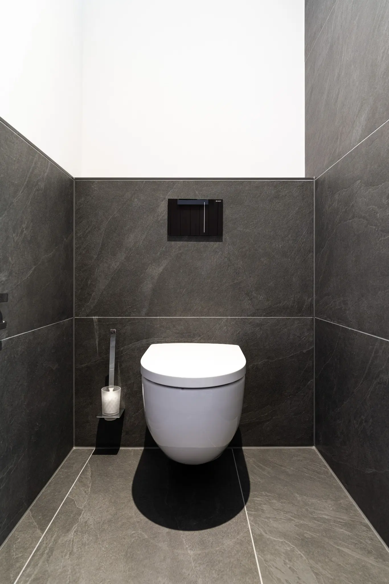 Separater WC-Bereich mit präzise ausgerichteten Wand- und Bodenfliesen